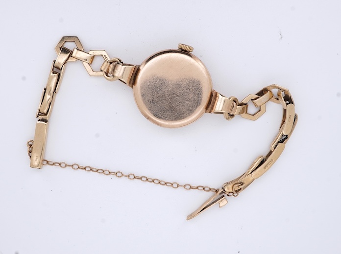 A lady's 9ct gold Record manual wind wrist watch, with Arabic dial and subsidiary seconds, on a 9ct gold bracelet, gross weight 16 grams. Condition - fair
